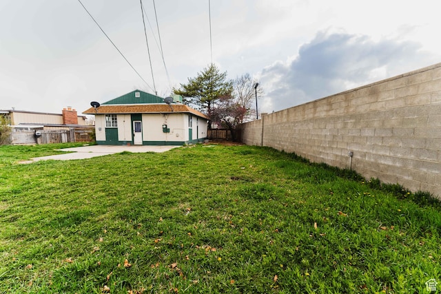 view of yard with a fenced backyard and a patio area