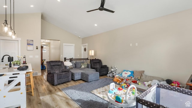 1887 N Maris St, Tooele, UT 84074 - living room with visible vents, ceiling fan, high vaulted ceiling, and light wood-style floors