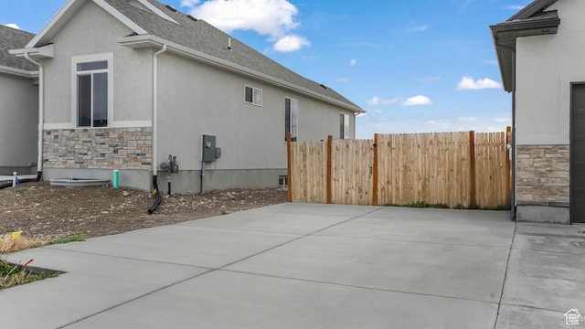 1887 N Maris St, Tooele, UT 84074 - view of home's exterior with fence, stucco siding, and stone siding