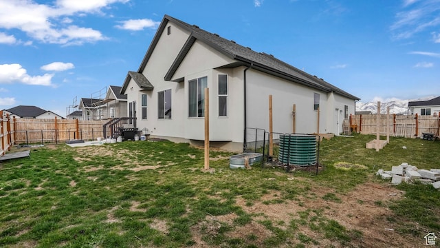 1887 N Maris St, Tooele, UT 84074 - exterior space with a yard, a fenced backyard, a residential view, and stucco siding