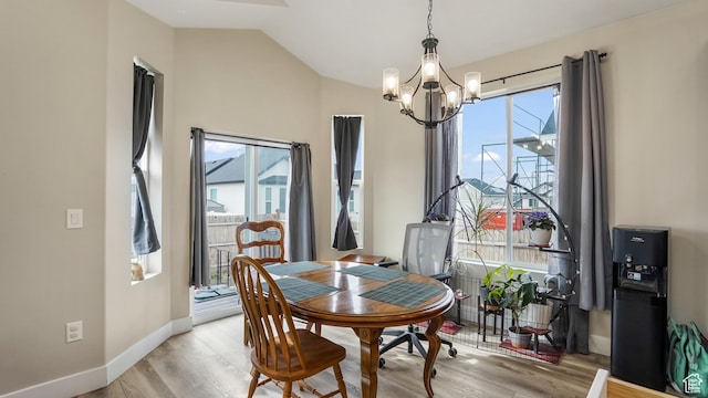 1887 N Maris St, Tooele, UT 84074 - dining room with a chandelier, light wood-style floors, baseboards, and vaulted ceiling