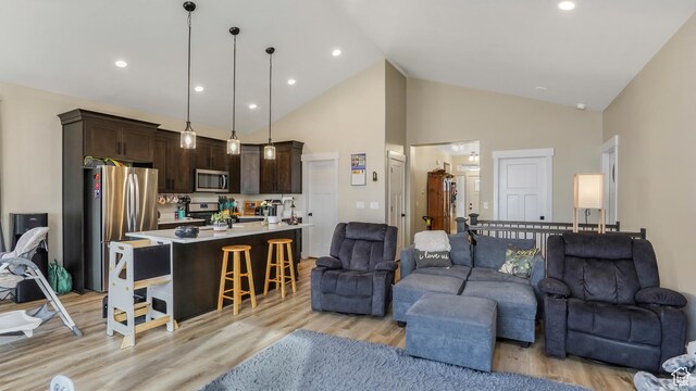 1887 N Maris St, Tooele, UT 84074 - living area with light wood-style flooring, high vaulted ceiling, and recessed lighting