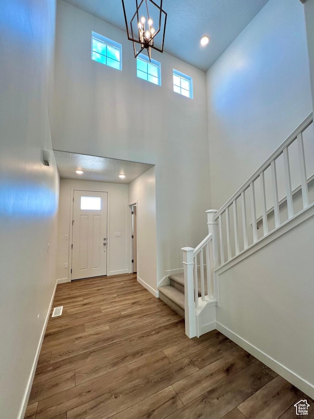 6293 W Jackson Crest Way, Herriman, UT 84096 - foyer entrance with baseboards, stairway, a high ceiling, and wood finished floors