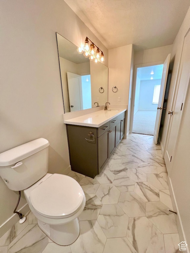 6293 W Jackson Crest Way, Herriman, UT 84096 - bathroom featuring toilet, marble finish floor, baseboards, and vanity