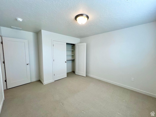 6293 W Jackson Crest Way, Herriman, UT 84096 - unfurnished bedroom with light carpet, a closet, baseboards, and a textured ceiling
