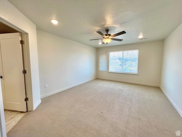 6293 W Jackson Crest Way, Herriman, UT 84096 - spare room with a textured ceiling, light colored carpet, baseboards, and a ceiling fan