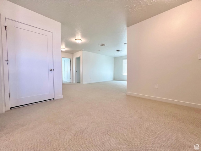 6293 W Jackson Crest Way, Herriman, UT 84096 - empty room featuring a textured ceiling, light colored carpet, baseboards, and visible vents