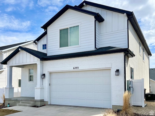 6293 W Jackson Crest Way, Herriman, UT 84096 - view of front facade with covered porch, a garage, board and batten siding, brick siding, and driveway