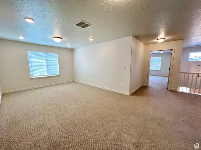 6293 W Jackson Crest Way, Herriman, UT 84096 - empty room with light carpet, visible vents, baseboards, and a textured ceiling