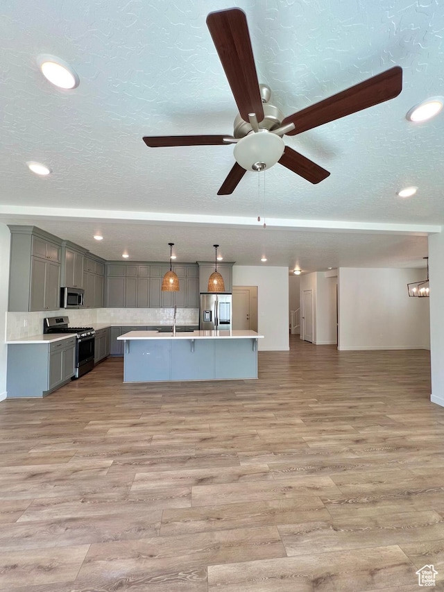 6293 W Jackson Crest Way, Herriman, UT 84096 - unfurnished living room with light wood-style floors, recessed lighting, a ceiling fan, and a textured ceiling