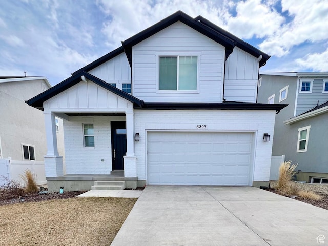 6293 W Jackson Crest Way, Herriman, UT 84096 - view of front of home with concrete driveway, board and batten siding, fence, and an attached garage