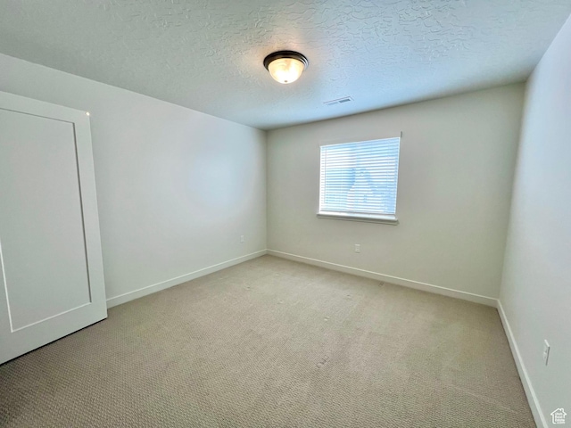 6293 W Jackson Crest Way, Herriman, UT 84096 - empty room with visible vents, baseboards, light carpet, and a textured ceiling