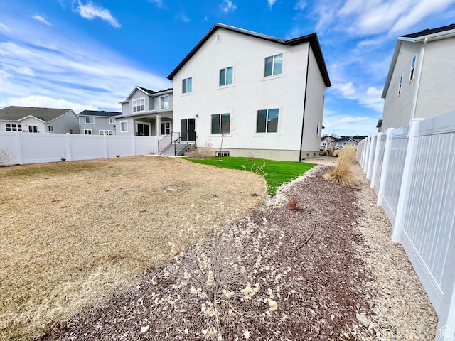 6293 W Jackson Crest Way, Herriman, UT 84096 - rear view of property featuring a yard and a fenced backyard