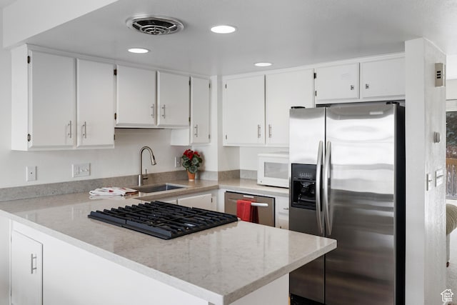 118 Davis Ct, Park City, UT 84060 - kitchen featuring white cabinetry, visible vents, light stone counters, a sink, and stainless steel appliances