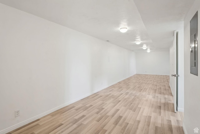 spare room featuring light wood-style flooring and baseboards