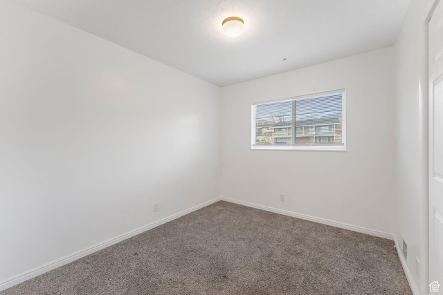 carpeted spare room with baseboards and visible vents