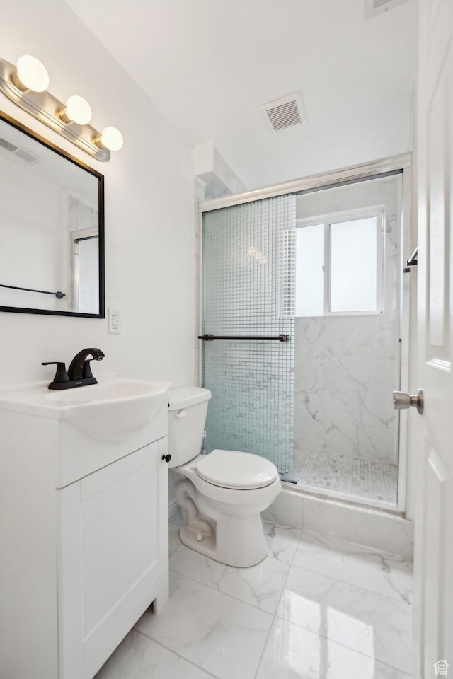 bathroom featuring a stall shower, marble finish floor, vanity, and visible vents