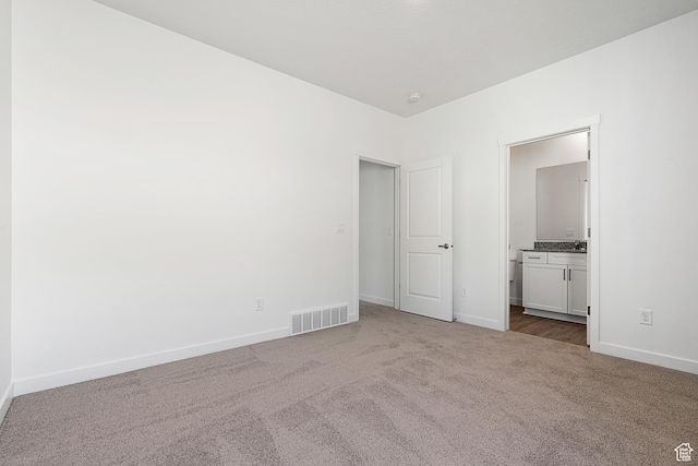 7137 Oquirrh Ranch Pkwy N, Eagle Mountain, UT 84005 - unfurnished bedroom with ensuite bath, visible vents, baseboards, and carpet floors