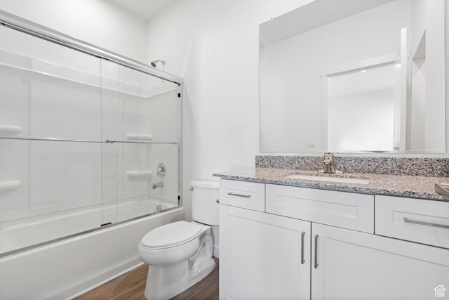 7137 Oquirrh Ranch Pkwy N, Eagle Mountain, UT 84005 - full bathroom with toilet, wood finished floors, vanity, and combined bath / shower with glass door