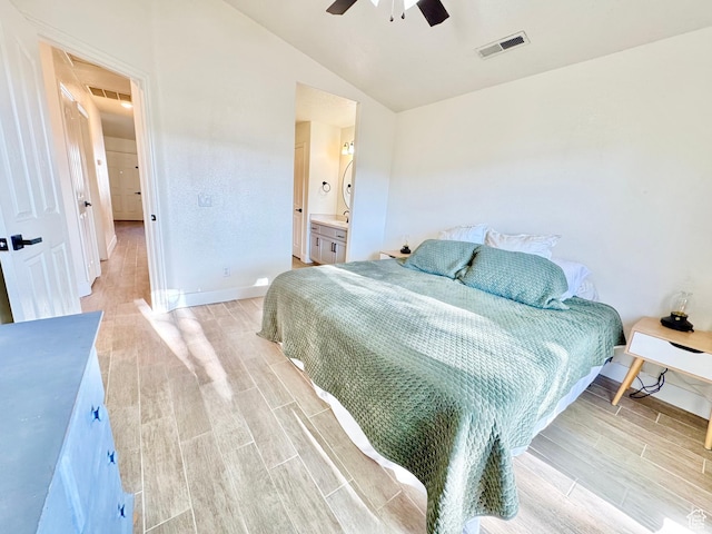 bedroom featuring baseboards, visible vents, vaulted ceiling, and wood tiled floor