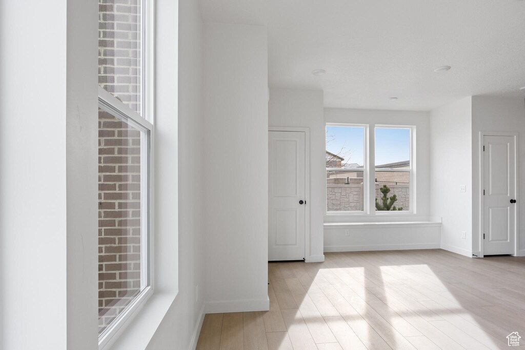 empty room featuring wood finished floors and baseboards