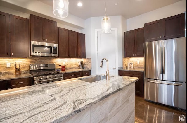 4277 W Canterbury Rd, Hurricane, UT 84737 - kitchen with pendant lighting, light stone countertops, tasteful backsplash, a sink, and stainless steel appliances