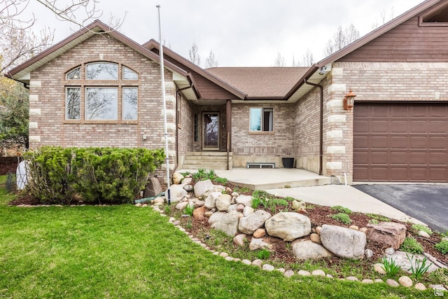 9106 N Upper Lando Ln, Park City, UT 84098 - ranch-style home with brick siding, a front yard, a garage, and asphalt driveway