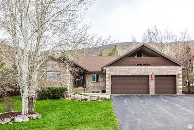 9106 N Upper Lando Ln, Park City, UT 84098 - view of front of home featuring brick siding, an attached garage, driveway, and a front yard