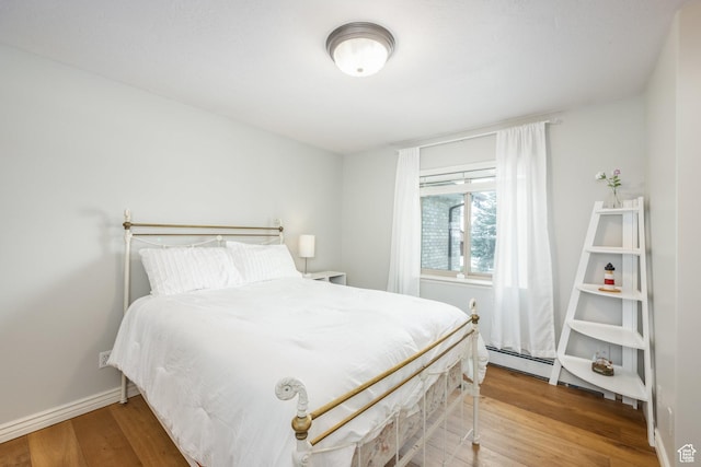 9106 N Upper Lando Ln, Park City, UT 84098 - bedroom with wood finished floors, baseboards, and baseboard heating