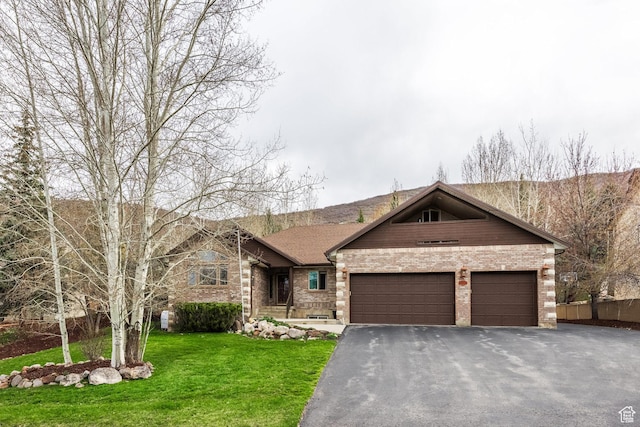 9106 N Upper Lando Ln, Park City, UT 84098 - view of front of property with brick siding, asphalt driveway, an attached garage, and a front lawn