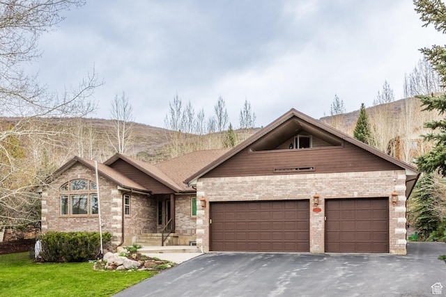 9106 N Upper Lando Ln, Park City, UT 84098 - view of front facade with asphalt driveway, brick siding, an attached garage, and a front lawn