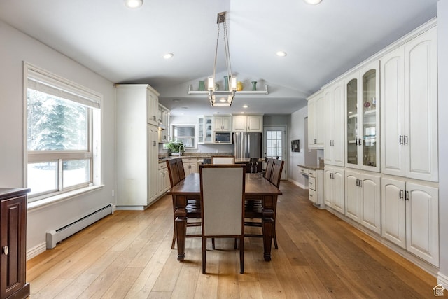 9106 N Upper Lando Ln, Park City, UT 84098 - dining space featuring baseboard heating, vaulted ceiling, light wood-style floors, and baseboards