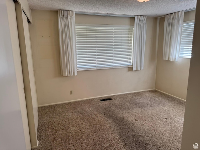 871 N Bonita Way E Unit 19, Centerville, UT 84014 - unfurnished room featuring carpet, visible vents, and a textured ceiling
