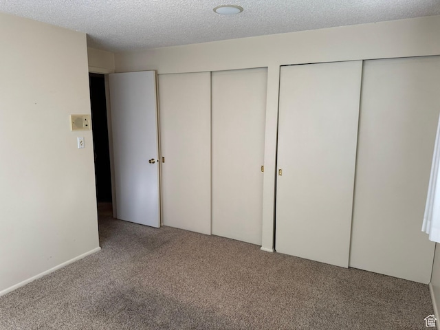 871 N Bonita Way E Unit 19, Centerville, UT 84014 - unfurnished bedroom with carpet floors, two closets, and a textured ceiling