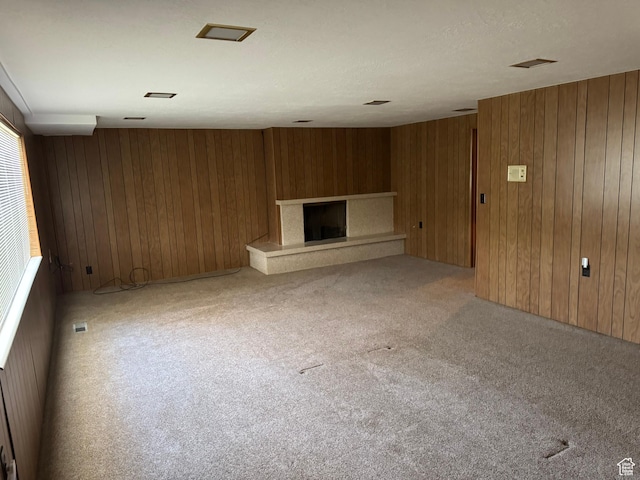 871 N Bonita Way E Unit 19, Centerville, UT 84014 - unfurnished living room featuring wooden walls, a fireplace with raised hearth, and light colored carpet