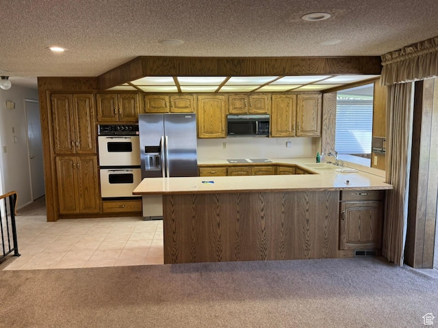 871 N Bonita Way E Unit 19, Centerville, UT 84014 - kitchen with light countertops, a peninsula, a sink, and black appliances
