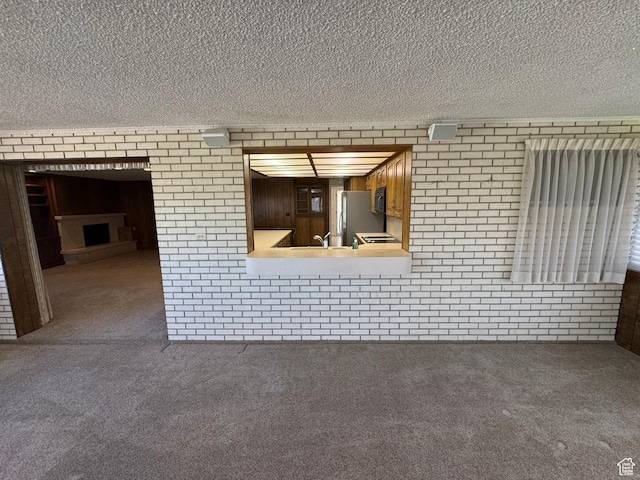 871 N Bonita Way E Unit 19, Centerville, UT 84014 - interior space with brick wall, carpet, and a textured ceiling