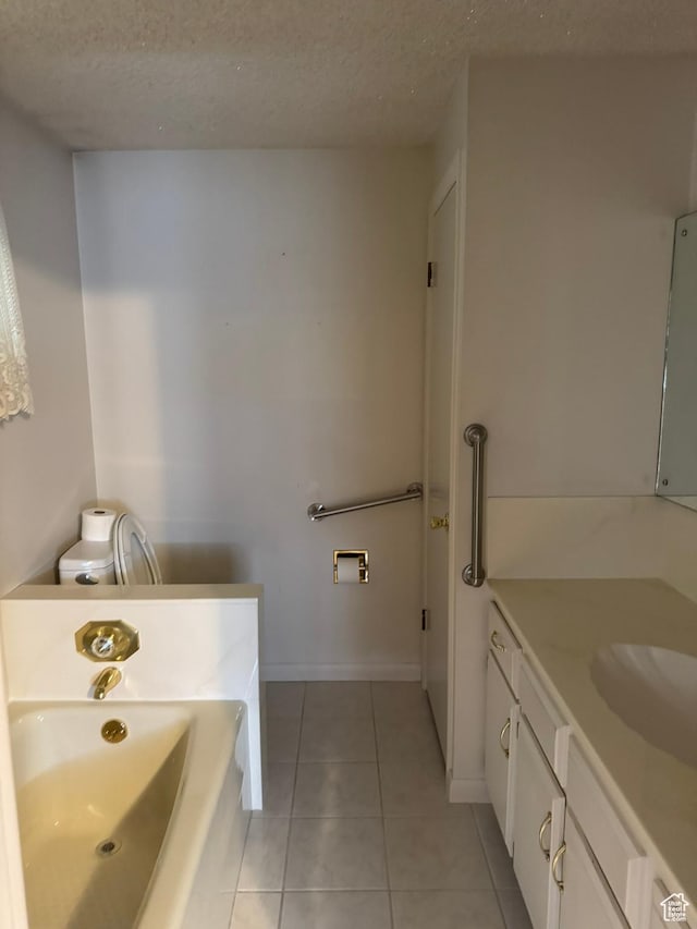 871 N Bonita Way E Unit 19, Centerville, UT 84014 - bathroom featuring baseboards, a bathing tub, a textured ceiling, vanity, and tile patterned floors