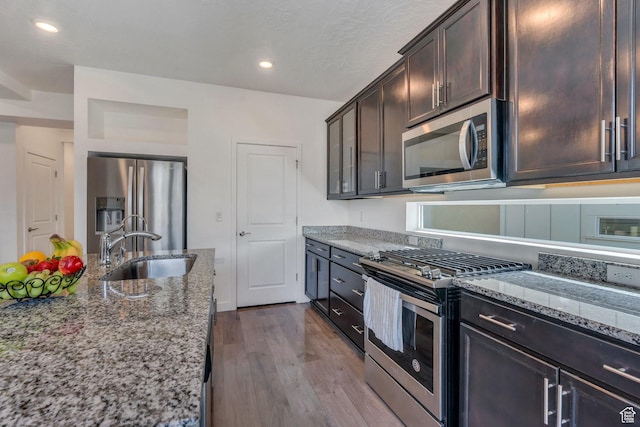 6156 W Poplar View Dr, South Jordan, UT 84009 - kitchen with dark wood finished floors, light stone countertops, dark brown cabinetry, appliances with stainless steel finishes, and a sink