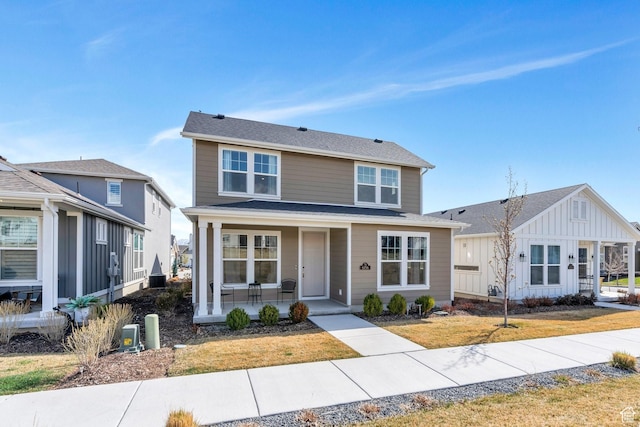 6156 W Poplar View Dr, South Jordan, UT 84009 - view of front of home featuring board and batten siding, covered porch, and a front yard