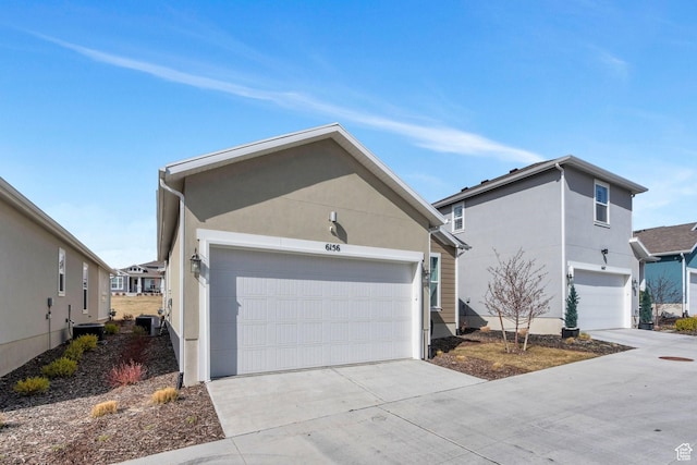 6156 W Poplar View Dr, South Jordan, UT 84009 - view of front facade featuring central air condition unit, a garage, stucco siding, and driveway