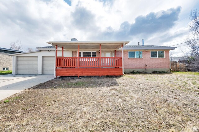 684 E Oquirrh Ave N, Tooele, UT 84074 - single story home featuring brick siding, a garage, and concrete driveway