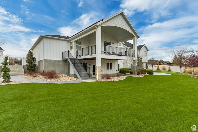 back of house with stairway, fence, and a lawn