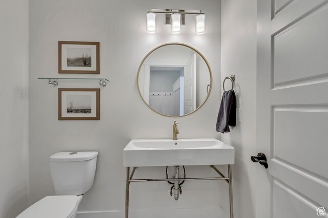 half bath with a sink and toilet