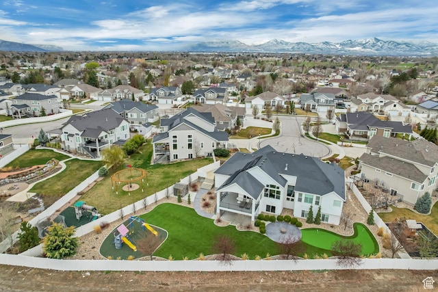 birds eye view of property with a mountain view and a residential view