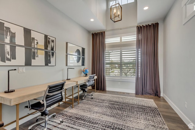 office space featuring baseboards, recessed lighting, built in study area, and dark wood finished floors