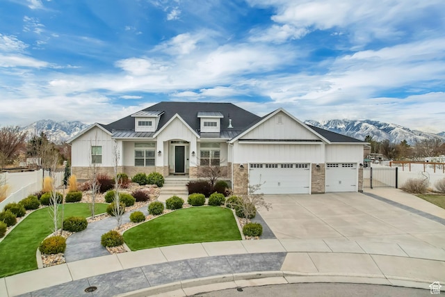 view of front of house featuring stone siding, metal roof, fence, a front lawn, and a standing seam roof