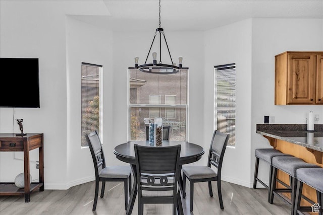 1277 W Las Hurdes Dr, St George, UT 84770 - dining space with baseboards, light wood-type flooring, and an inviting chandelier