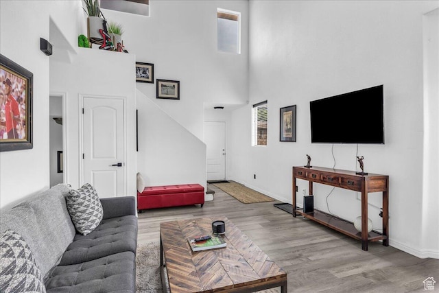 1277 W Las Hurdes Dr, St George, UT 84770 - living room with wood finished floors, a towering ceiling, and baseboards