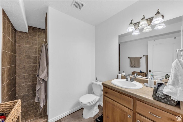 1277 W Las Hurdes Dr, St George, UT 84770 - full bath with tiled shower, vanity, visible vents, toilet, and baseboards